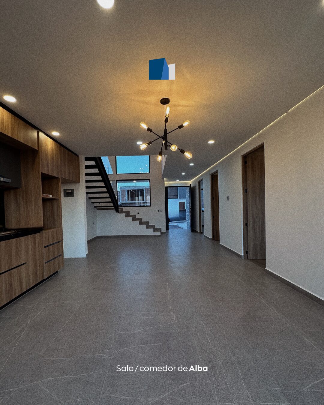 Sala y comedor de concepto abierto con escalera de Casa Alba · residencia moderna en Morelia, Michoacán